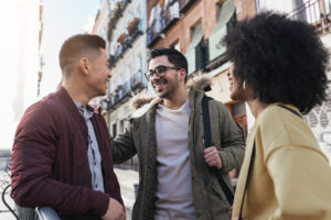 A group of friends smiling and chatting casually, creating an authentic moment, leading to word of mouth referrals.