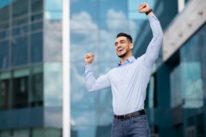 A male employee celebrating career success.